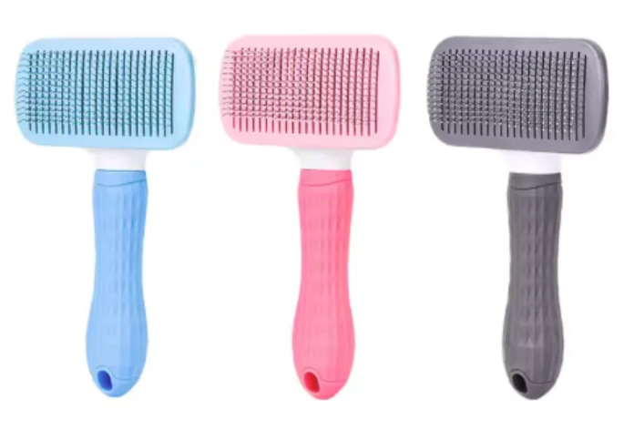 Self-cleaning pet hair removal brush for cats and dogs in blue, pink, and gray